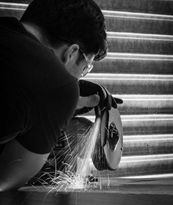 Precision grinding work on a Nimbus suspension component, sparks flying