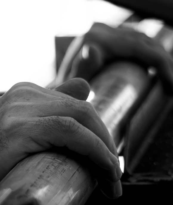 Close-up of hands holding a Nimbus cylinder component