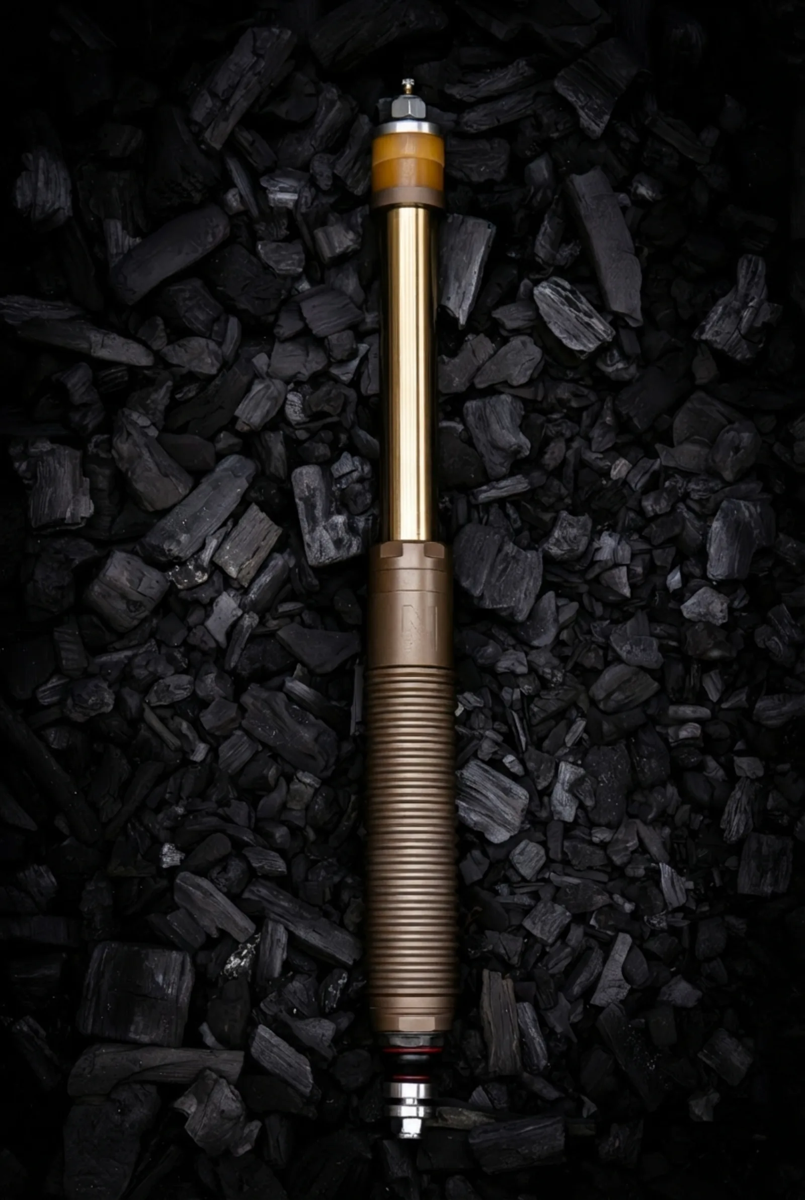 Erebus hard-anodized aluminum body on charcoal, gold TiN rod visible