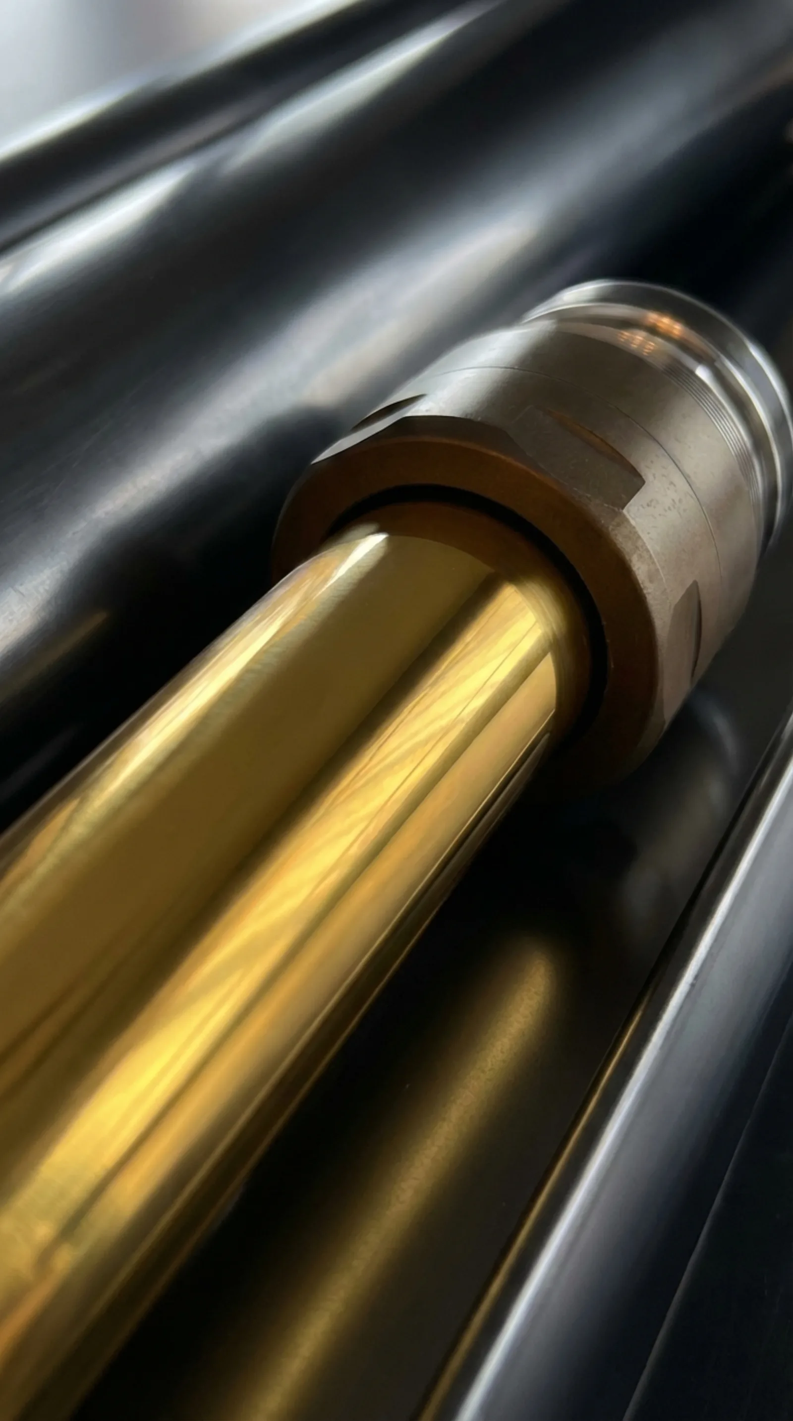 Close-up of the golden TiN-coated rod on a Nimbus Erebus