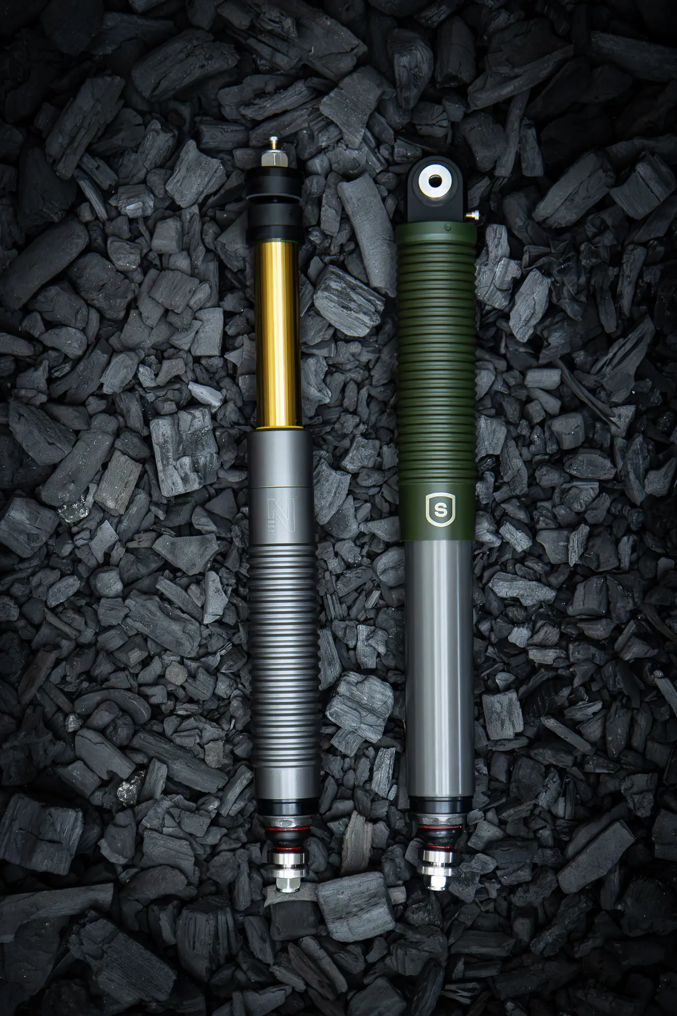 Nimbus Erebus and Squire Editions custom struts side by side on charcoal