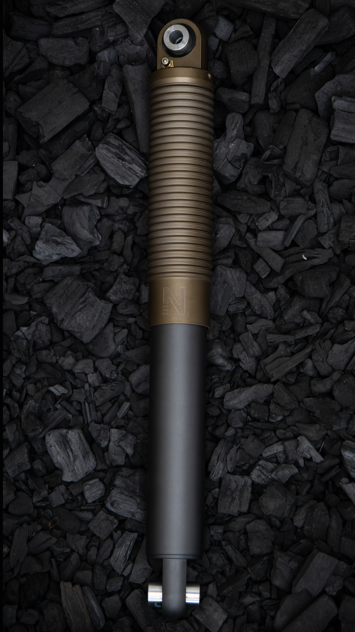 Nimbus Erebus oleo-pneumatic suspension unit, bronze and black sealed body on charcoal