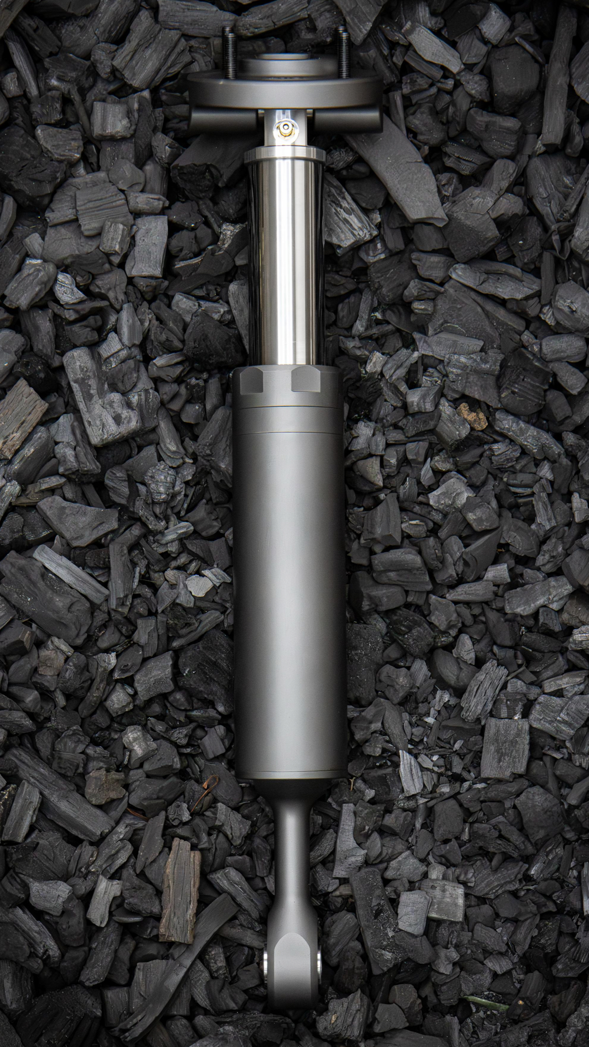 Nimbus Goliath V2 oleo-pneumatic suspension unit, gunmetal body with top mount on charcoal